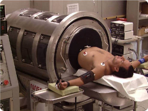 Astronaut using a Lower Body Negative Pressure Device to improve blood circulation